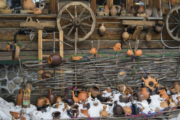 on a wooden wall posted earthenware jugs for sale