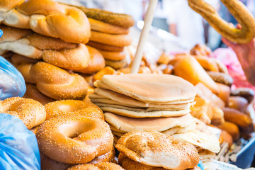 Fresh traditional jewish pastry - buns, Challah, pitta bread for Shabbat on Tel Aviv marketplace. Selective focus. Space for text.
