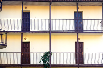Two floors with wooden doors. Interrior of hostel.