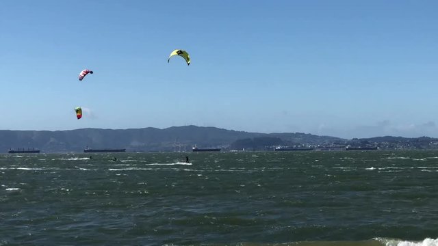 4K HD video of people kite surfing in the San Francisco Bay. Wind is the key element to kiteboarding and it is important to know the direction, speed, and orientation to ensure it is safe to kitesurf.