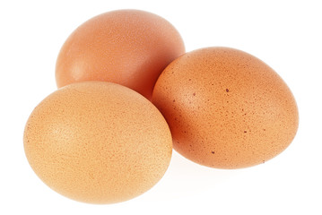 Three brown chicken eggs isolated on a white background