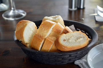 Spanish fresh bread on a basket on a restaurant table.