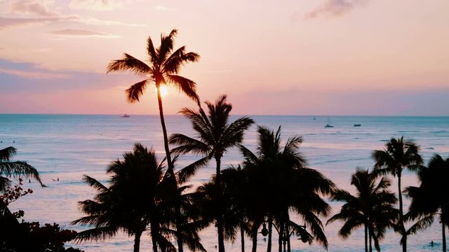 Professional video of orange sunset in Waikiki beach Hawaii in 4k slow motion 60fps