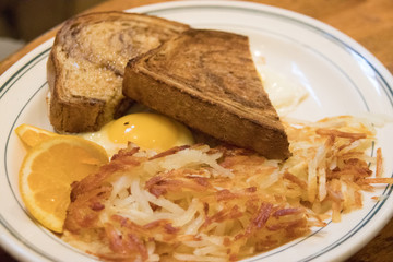 A country breakfast of toast, egg and hash browns