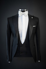 Tailored suit, tuxedo isolated on black background on mannequin