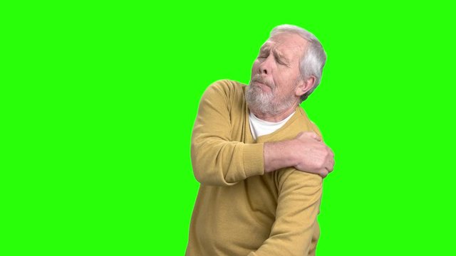 Elderly man having shoulder pain. Mature man suffering from arthritis, chroma key background.