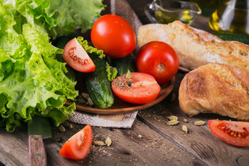 tomato, cucumber, lettuce, baguette, olive oil and spices