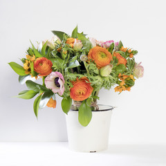 wedding bouquet of buttercups, anemones and Ruscus