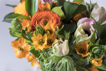 wedding bouquet of buttercups, anemones and Ruscus