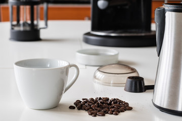 Morning coffee in the kitchen. Coffee grinder and coffee maker with coffee makers on a white kitchen table.