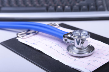 Stethoscope on a modern keyboard, RX prescription on white table with space for text © v_l