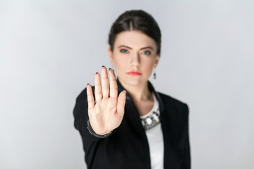 Focus on hand. Seriously woman showing stop hand sign