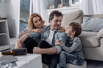 New start. Calm man feeling good after getting rid of alcoholism and smiling while sitting on the...