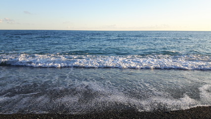 Amazing caption of the seaside of Varazze in winter with some waves and some wind and a beautiful blue sky