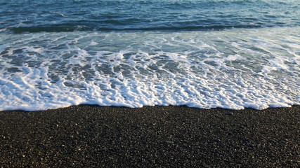 Amazing caption of the seaside of Varazze in winter with some waves and some wind and a beautiful blue sky