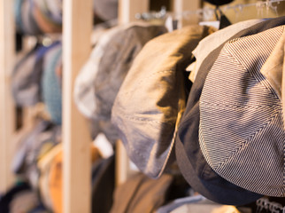 newboys cap hats hanging on the wall in mall