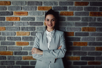 Fototapeta na wymiar Classic business portrait of young woman with crossed arms.