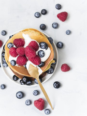 Delicious crepes with fresh blueberry and raspberry.  An healthy meal of Pancakes with berries.