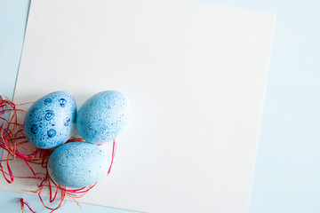 Blue Easter eggs on light background, top view, copy space