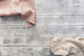 Natural linen napkin on wooden background. Pastel tones