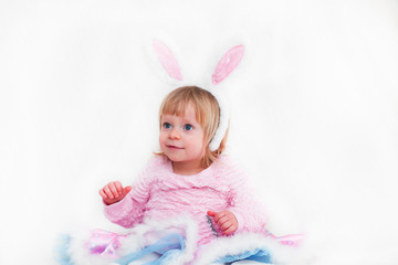 Obraz na płótnie Canvas Closeup Portrait of Blonde Baby 18 month old Girl with Big Blue Eyes and Bunny Ears headband, Pink Tutu, isolated on white background.