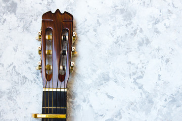 Acoustic classic guitar head on white background. Simple musical instrument with copy space.