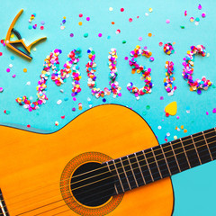 Acoustic classic guitar on blue background with lettering word 