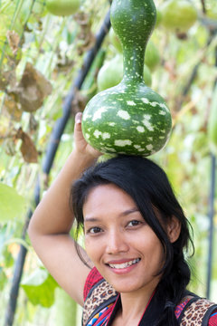 Asian woman holding on her head Lagenaria siceraria (Molina) Standl, Calabash.