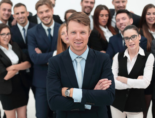 happy businessman standing on background of her business team.