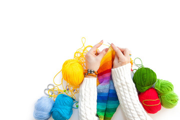 Women crochet and knitting from colored yarn. View from above.