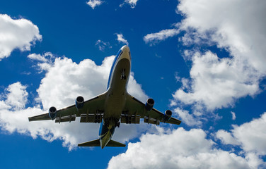 The plane on a background of blue sky and white clouds.