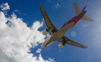 The plane on a background of blue sky and white clouds.