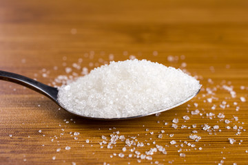 white sugar spoon bamboo table. copy space, close up, selective focus