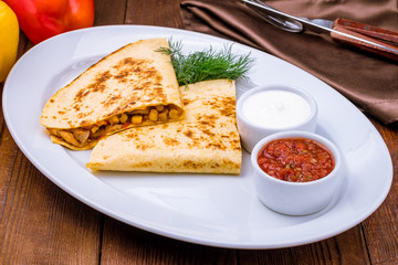 Quesadilla with chicken and sauces