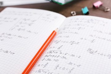 Exercise book with homework on table, closeup