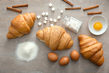 Composition with tasty croissants on table