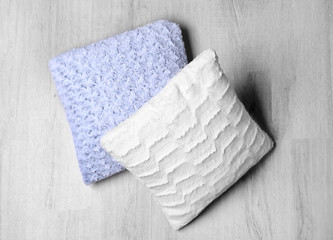 Two soft pillows on wooden floor