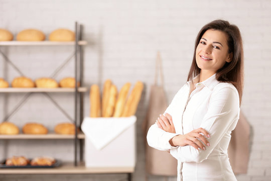 Portrait of young woman in bakery. Small business owner