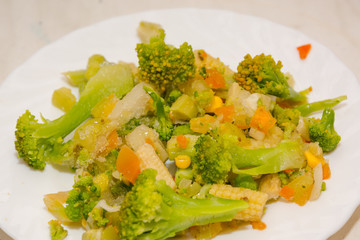 Frozen vegetables. Vegetables from the freezer. Vegetables on a white plate frozen.