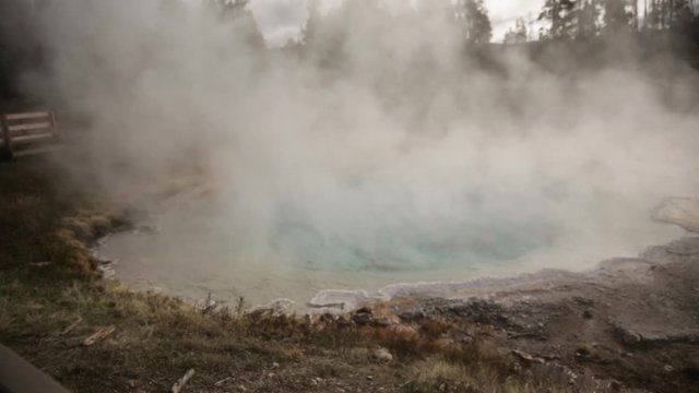 Steam Rising from Clear Blue Hot Springs in Yellowstone National Park