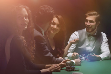 players sitting at the playing table in the casino