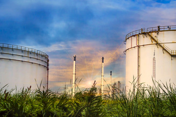 Distillation tank of oil refinery plant, twilight time.
