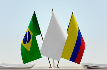 Flags of Brazil and Colombia with a white flag in the middle