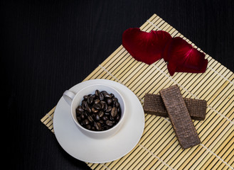 Black coffee is placed in a white cup with a black wooden frame.