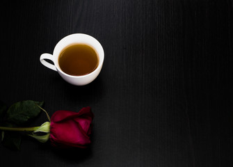 Black coffee is placed in a white cup with a black wooden frame.