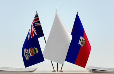 Flags of Cayman Islands and Haiti with a white flag in the middle