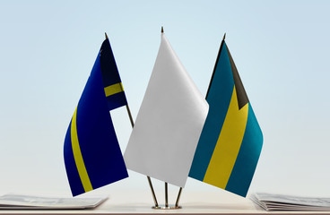 Flags of Curacao and Bahamas with a white flag in the middle