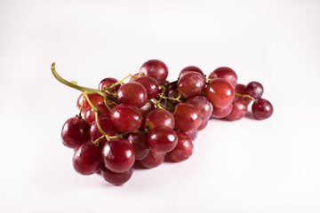 red grapes with stalks isolated on white background. fresh red grapes