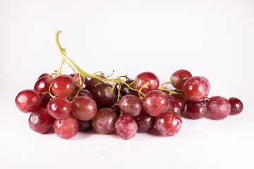 red grapes with stalks isolated on white background. fresh red grapes