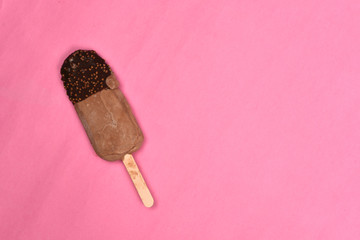 chocolate flavored ice cream isolated on pink background. sweet food concept